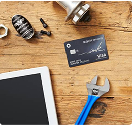 Tools and a tablet surrounding a Ink Business Unlimited card on a wooden table