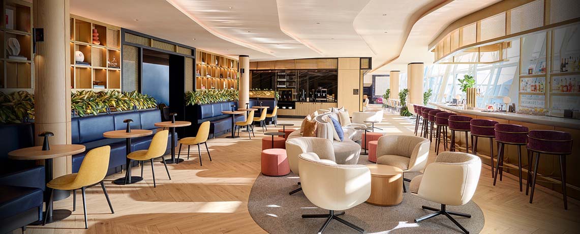 Sapphire Lounge at John F. Kennedy International Airport, New York, with round tables, armchairs, a bar area, and large windows.