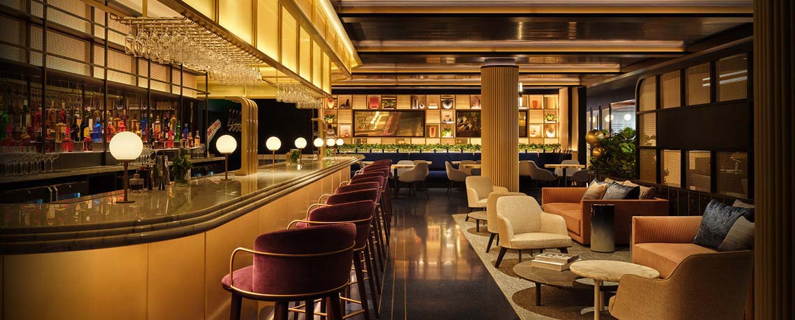 Sapphire Lounge at Philadelphia International Airport with a long bar counter, high chairs, elegant lighting, and plush seating areas.