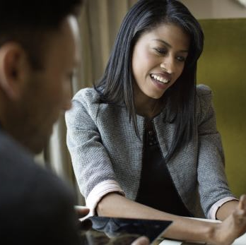 Two small business owners happily make a purchase online with their Ink card