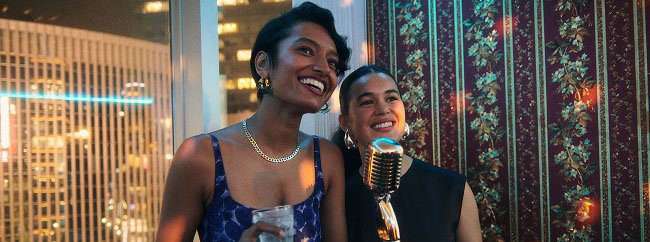 Two people performing karaoke in Japan.