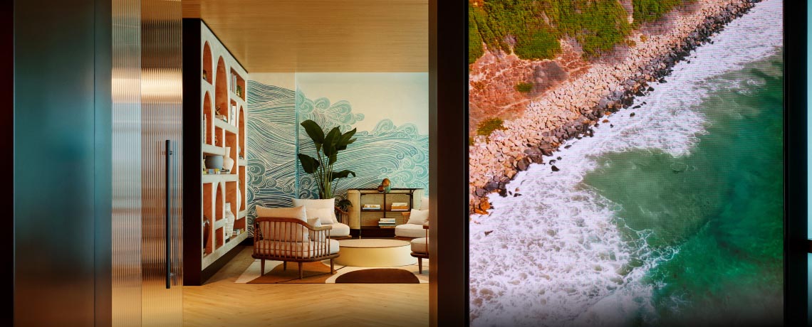 Sapphire Lounge at San Diego International Airport with contemporary furniture and a large mural of ocean waves.