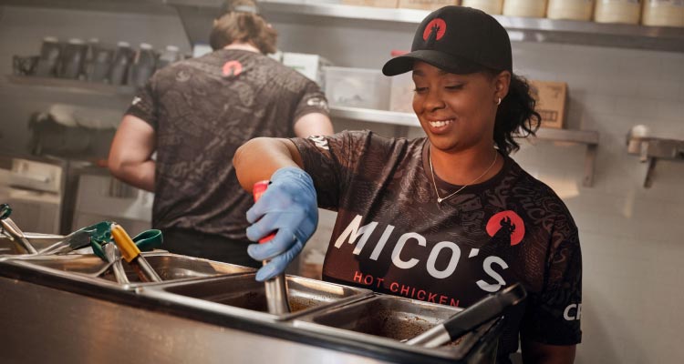 Worker making food with a smile