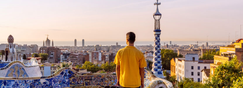 A man overlooks a city in Spain from a rooftop