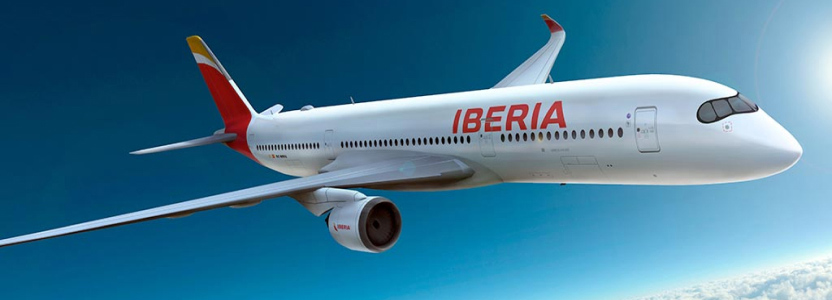 Iberia airplane in flight above the clouds