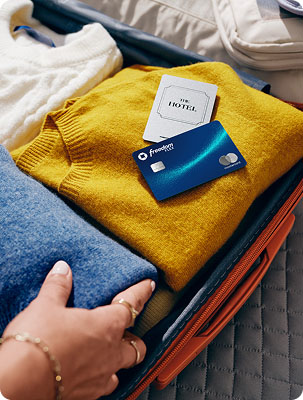 The Chase Freedom Flex Credit Card Mastercard contactless icon on top of folded clothes in a suitcase 