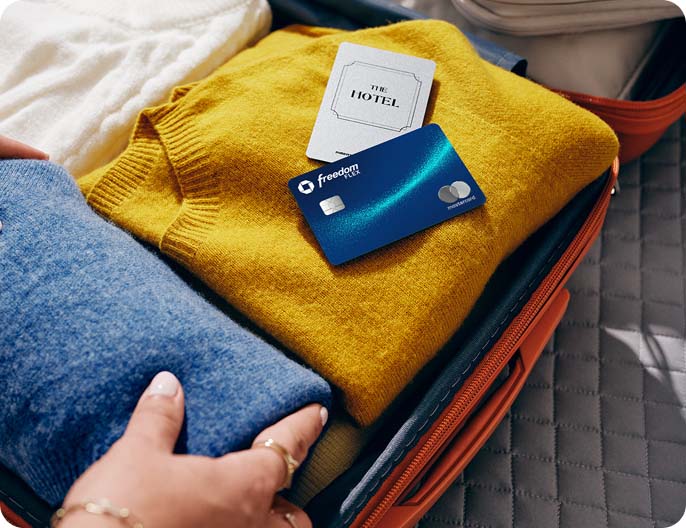 The Chase Freedom Flex Credit Card Mastercard contactless icon on top of folded clothes in a suitcase 
