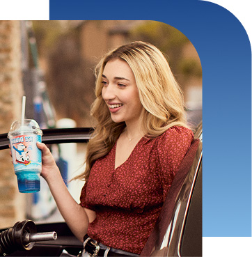 Girl holding slurpee and smiling