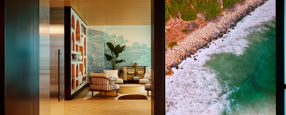 Sapphire Lounge at San Diego International Airport with contemporary furniture and a large mural of ocean waves.