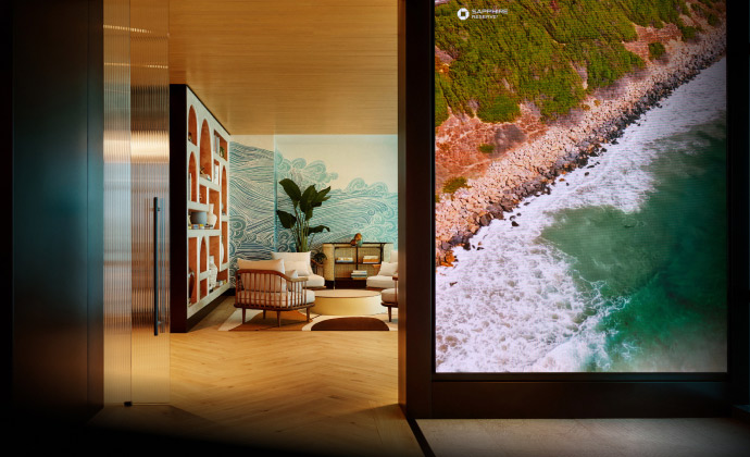 Sapphire Lounge at San Diego International Airport with contemporary furniture and a large mural of ocean waves.