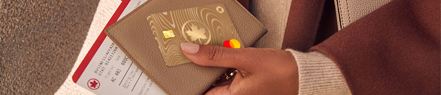 Close up shot of a passenger holding her Air Canada card and boarding pass