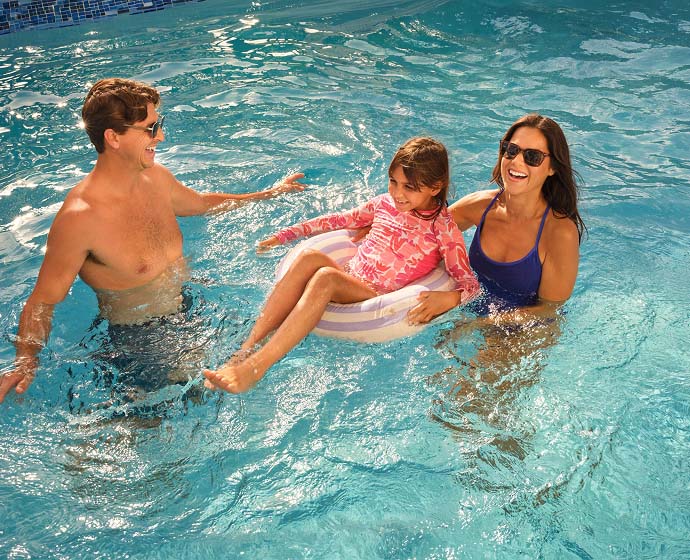 A young family enjoying their time in the pool