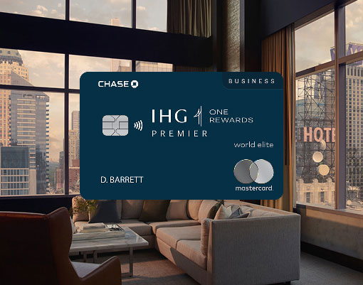 IHG One Rewards Premier Business credit card displayed in front of a modern hotel room with city views