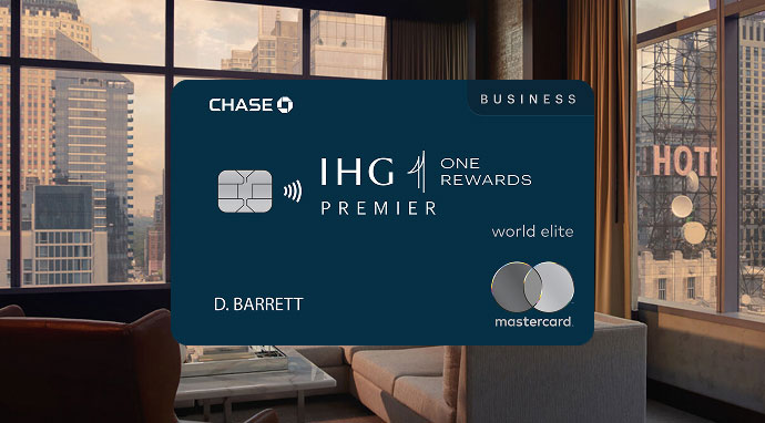 IHG One Rewards Premier Business credit card displayed in front of a modern hotel room with city views