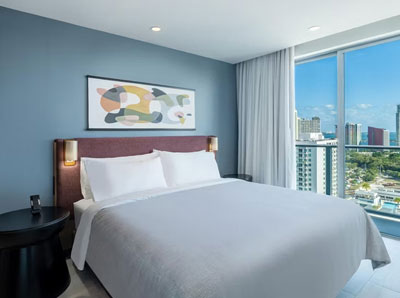 Bedroom interior at Atwell Suites Miami Brickell with city views