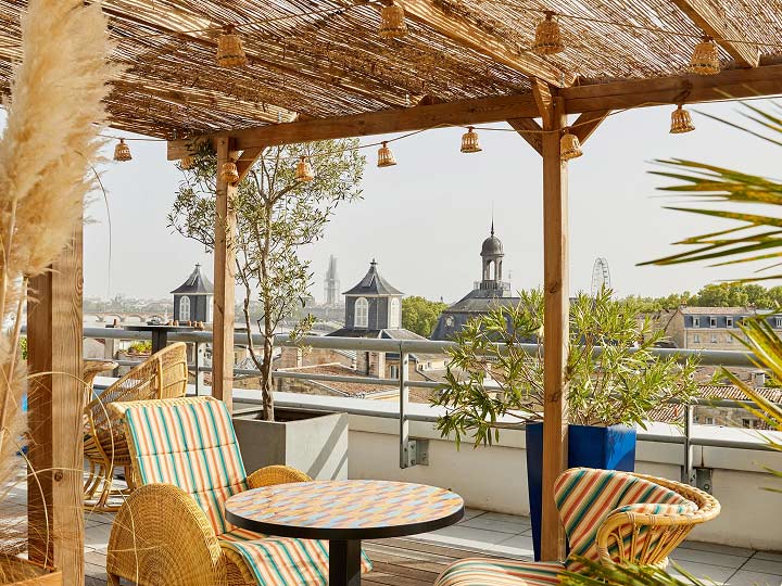 Outdoor terrace with seating at Hotel Indigo Bordeaux Centre Chartrons in Bordeaux, France