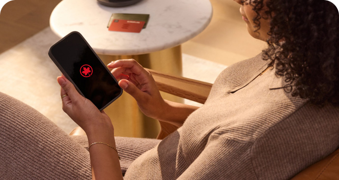 Illustration of Aeroplan program card and smartphone featuring the Air Canada app 