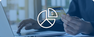 Person using a credit card at a laptop, representing partial payment with Avios.