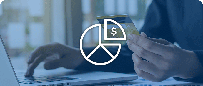 Person using a credit card at a laptop, representing partial payment with Avios.