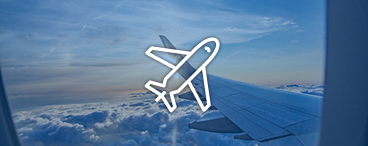 View from an airplane window showing a wing above the clouds, representing reward flights.