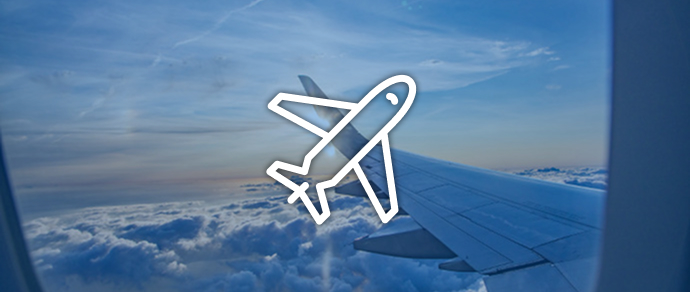 View from an airplane window showing a wing above the clouds, representing reward flights.