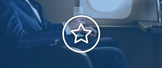Passenger seated by an airplane window, representing booking upgrades with Avios.