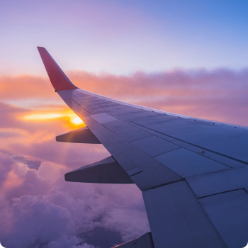 View of airplane wing above clouds