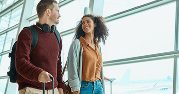 Travelers walking through an airport terminal.