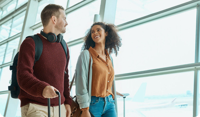 Travelers walking through an airport terminal.