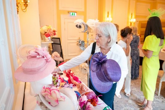 Guest browsing hats on display table