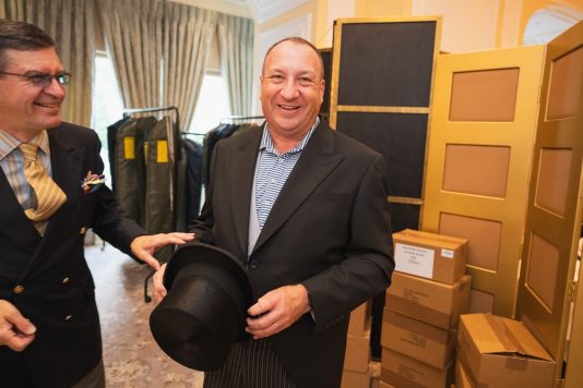 Guest holding top hat at styling station