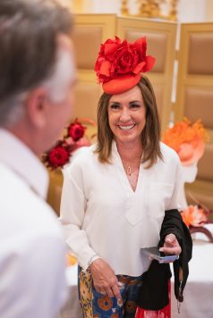 Guest in a red floral fascinator