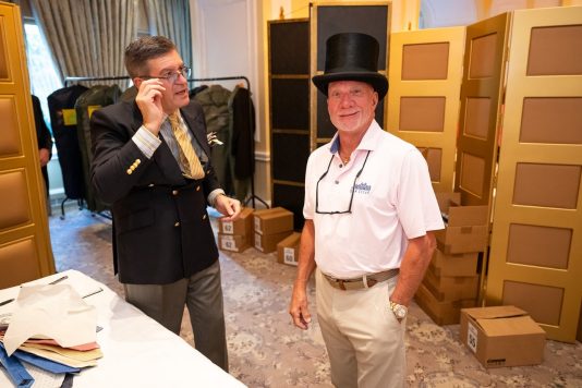 Guest wearing top hat at event station