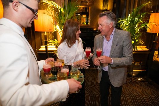 Guests mingling with cocktails