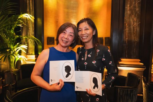 Two guests displaying silhouette artwork