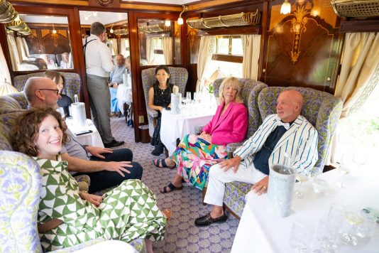 Passengers socializing aboard luxury train