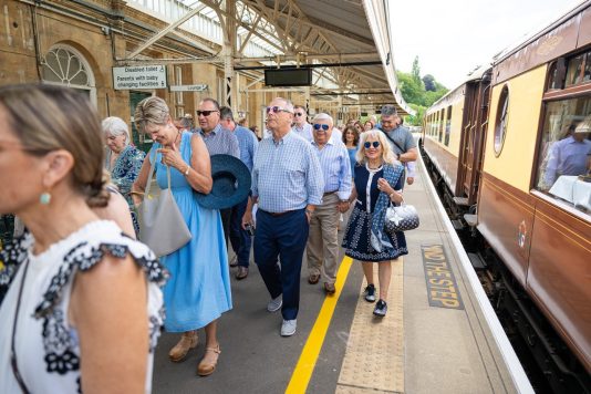 Guests walking along train platform