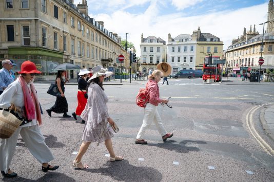 Guests crossing city street