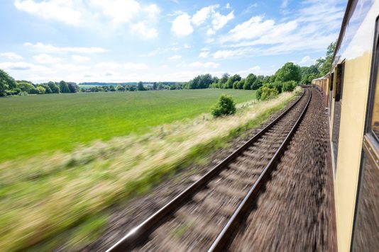 View from moving train through countryside