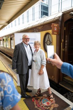 Guests posing for photo in front of British Pullman