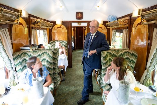 Train host speaking with passengers