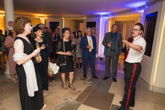Guide speaking to guests at reception