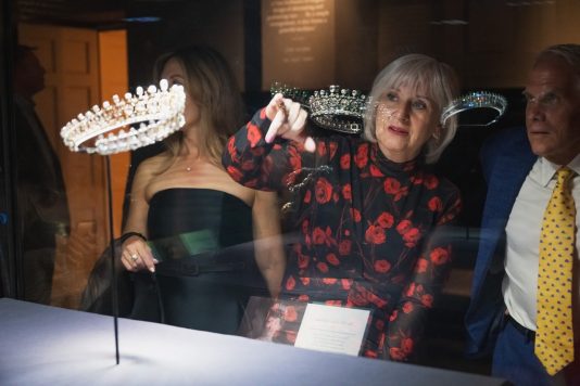 Guest examining royal tiara collection