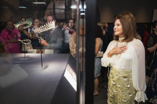 Guest viewing royal tiara exhibit