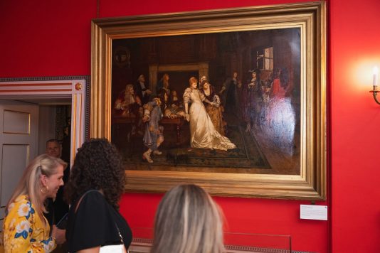 Guests viewing historic painting