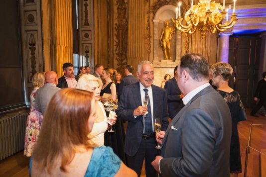 Guests mingling in historic hall