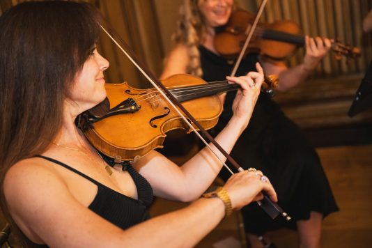 Two violinists performing