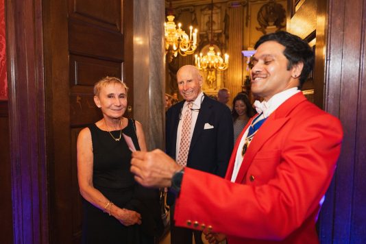 Speaker greeting guests at Kensington Palace
