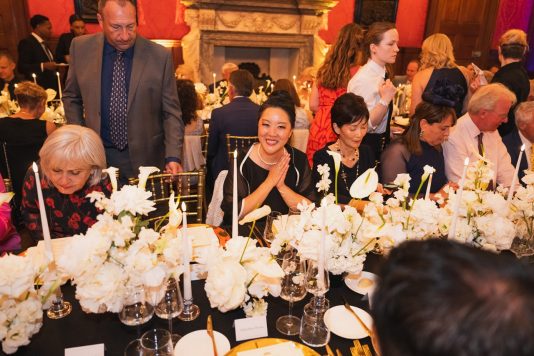 Guests seated at formal palace dinner