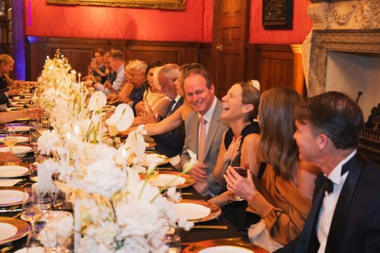 Dinner guests seated in historic hall